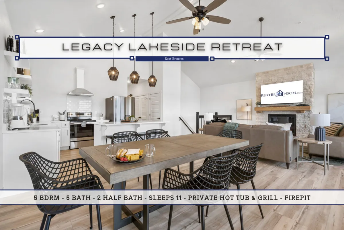 A welcoming interior shot showing a spacious dining table, adjacent kitchen, comfortable living seating, and a prominent stone fireplace. The setup suggests family meals, group games, and shared relaxation, all within a unified main space.